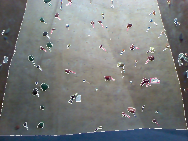 Indoor rock climbing wall with holds outlines overlayed